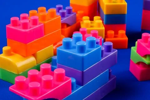 Plastic building blocks isolated on blue background Fotos de archivo
