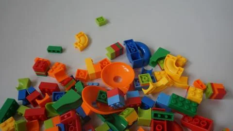Plastic building blocks on a white background, close-up. Stock Photos