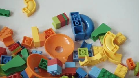 Plastic building blocks on a white background, close-up. Stock Photos