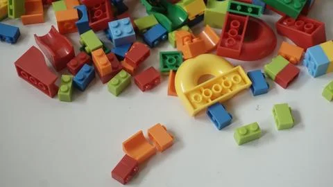 Plastic building blocks on a white background, close-up. Stock Photos