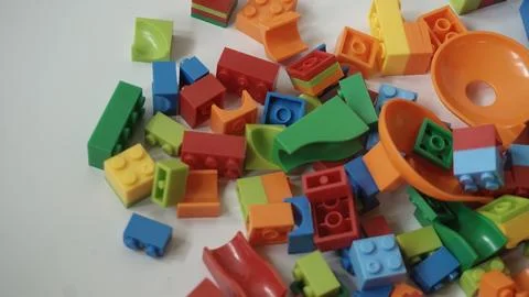Plastic building blocks on a white background, close-up. Stock Photos