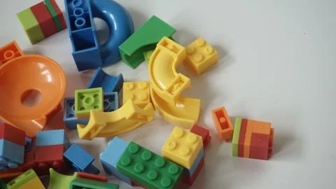 Plastic building blocks on a white background, close-up. Stock Photos