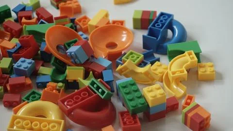 Plastic building blocks on a white background, close-up. Stock Photos