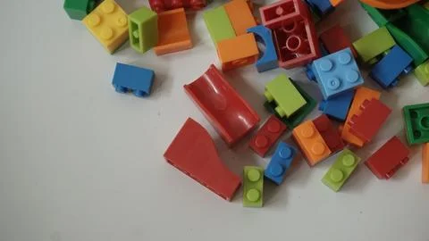 Plastic building blocks on a white background, close-up. Stock Photos