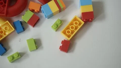 Plastic building blocks on a white background, close-up. Stock Photos