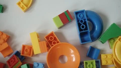 Plastic building blocks on a white background, close-up. Stock Photos