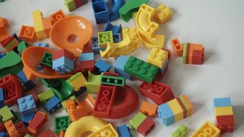 Plastic building blocks on a white background, close-up. Stock Photos