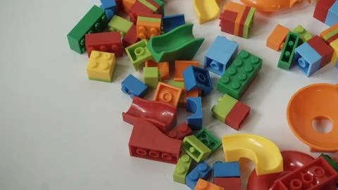 Plastic building blocks on a white background, close-up. Stock Photos
