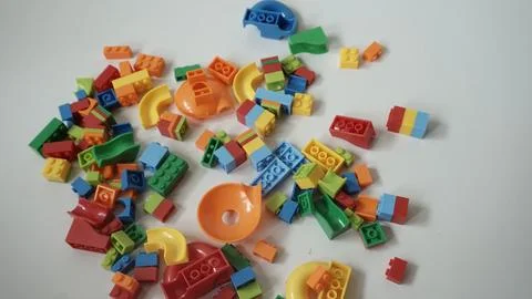 Plastic building blocks on a white background, close-up. Stock Photos