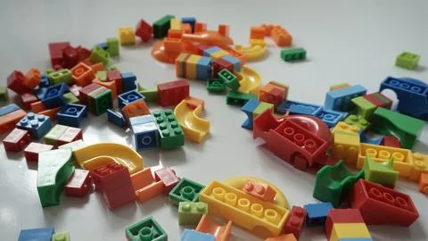 Plastic building blocks on a white background, close-up. Stock Photos
