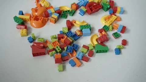 Plastic building blocks on a white background, close-up. Stock Photos