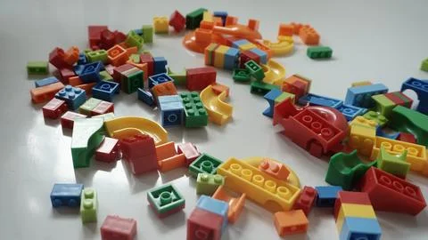 Plastic building blocks on a white background, close-up. Stock Photos