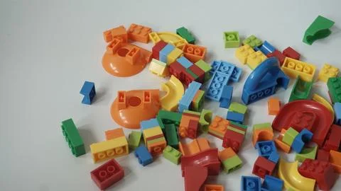 Plastic building blocks on a white background, close-up. Stock Photos