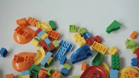 Plastic building blocks on a white background, close-up. Stock Photos