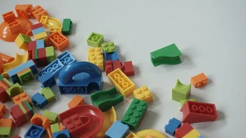 Plastic building blocks on a white background, close-up. Stock Photos