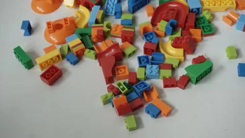 Plastic building blocks on a white background, close-up. Foto stock