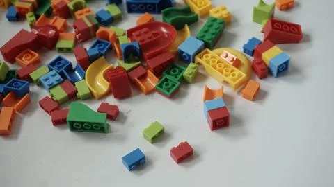 Plastic building blocks on a white background, close-up. Stock Photos
