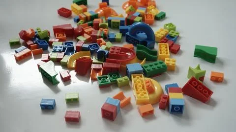 Plastic building blocks on a white background, close-up. Fotos de archivo