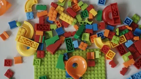 Plastic building blocks on a white background, close-up. Stock Photos