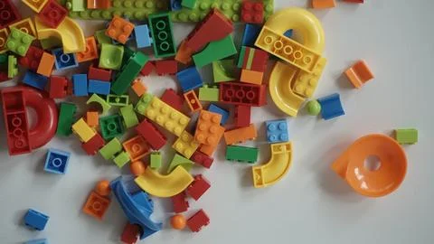 Plastic building blocks on a white background, close-up. Stock Photos
