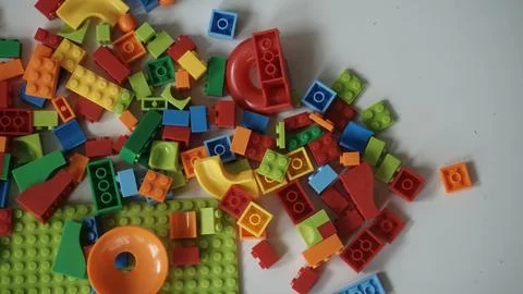 Plastic building blocks on a white background, close-up. Stock Photos