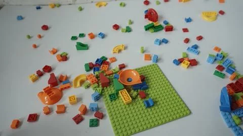 Plastic building blocks on a white background, close-up. Stock Photos