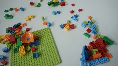 Plastic building blocks on a white background, close-up. Stock Photos