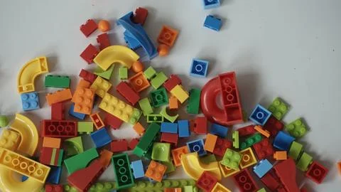Plastic building blocks on a white background, close-up. Stock Photos