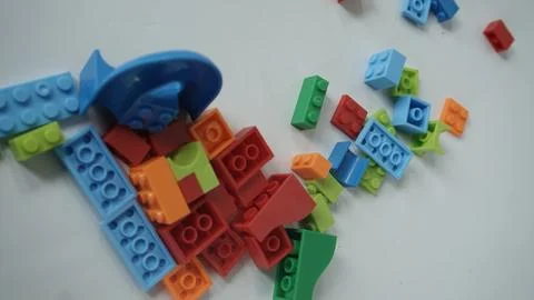 Plastic building blocks on a white background, close-up. Stock Photos