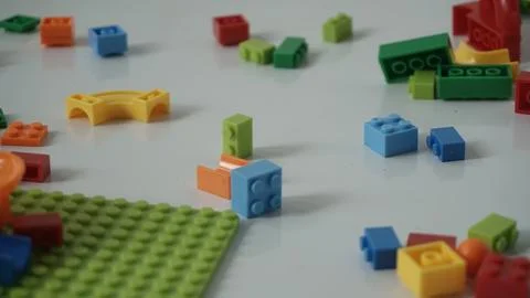 Plastic building blocks on a white background, close-up. Stock Photos