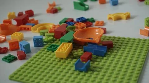 Plastic building blocks on a white background, close-up. Stock Photos