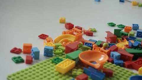 Plastic building blocks on a white background, close-up. Stock Photos