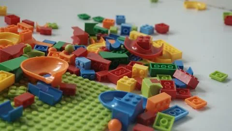 Plastic building blocks on a white background, close-up. Stock Photos