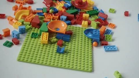 Plastic building blocks on a white background, close-up. Stock Photos