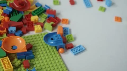 Plastic building blocks on a white background, close-up. Stock Photos
