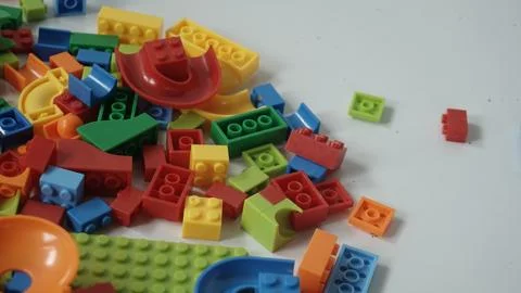 Plastic building blocks on a white background, close-up. Stock Photos