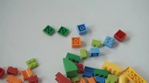 Plastic building blocks on a white background, close-up. Stock Photos