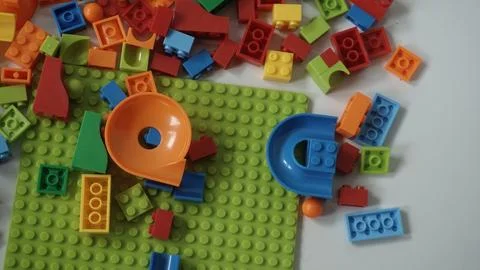 Plastic building blocks on a white background, close-up. Stock Photos