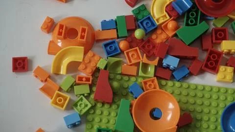 Plastic building blocks on a white background, close-up. Stock Photos