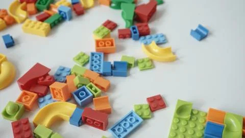 Plastic building blocks on a white background, close-up. Stock Photos