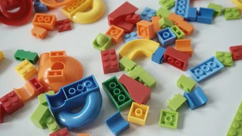 Plastic building blocks on a white background, close-up. Stock Photos
