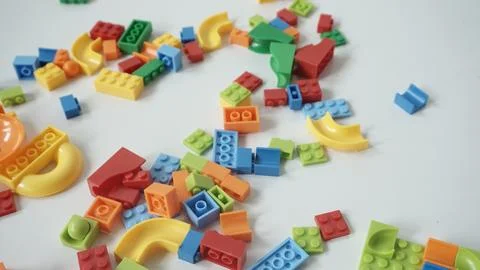 Plastic building blocks on a white background, close-up. Stock Photos