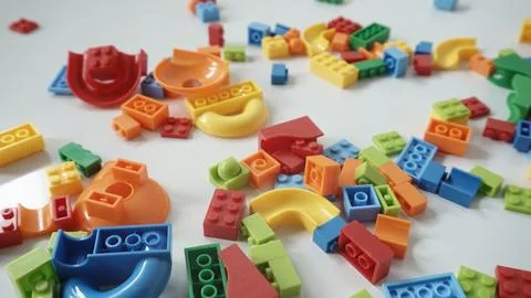 Plastic building blocks on a white background, close-up. Stock Photos