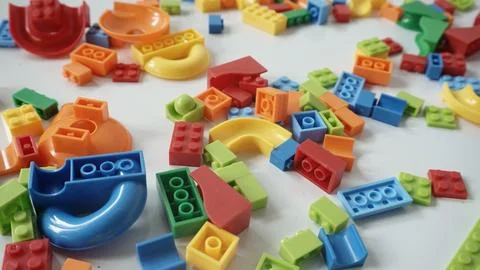 Plastic building blocks on a white background, close-up. Foto stock