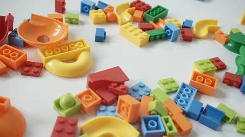 Plastic building blocks on a white background, close-up. Stock Photos