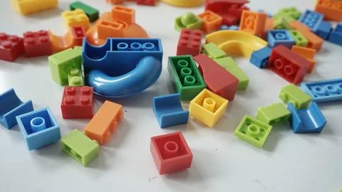 Plastic building blocks on a white background, close-up. Stock Photos