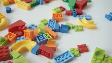 Plastic building blocks on a white background, close-up. Stock Photos