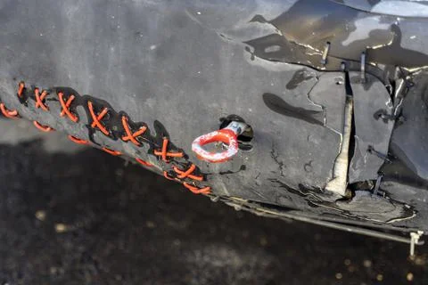 The plastic bumper of the car is repaired with wire and ties Stock Photos
