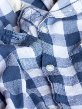 Plastic button on a shirt Stock Photos