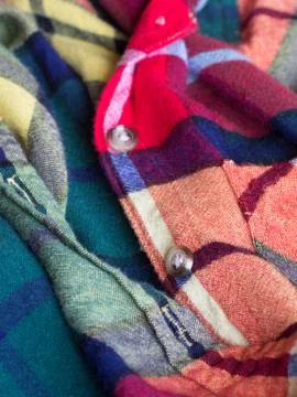 Plastic button on a shirt Stock Photos